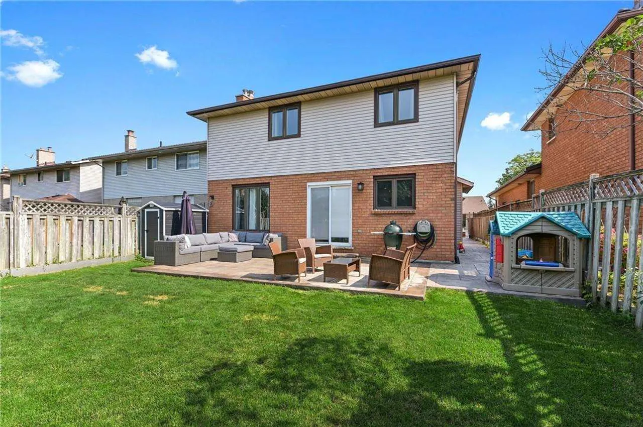 Rear exterior showing the covered patio and fenced backyard