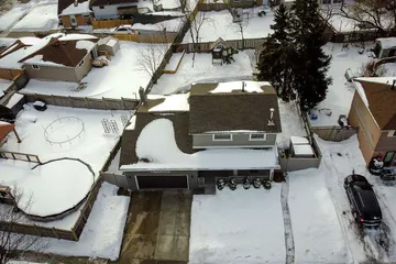 Aerial winter exterior view of 9 Hopewell Crescent showing the home, driveway, and backyard