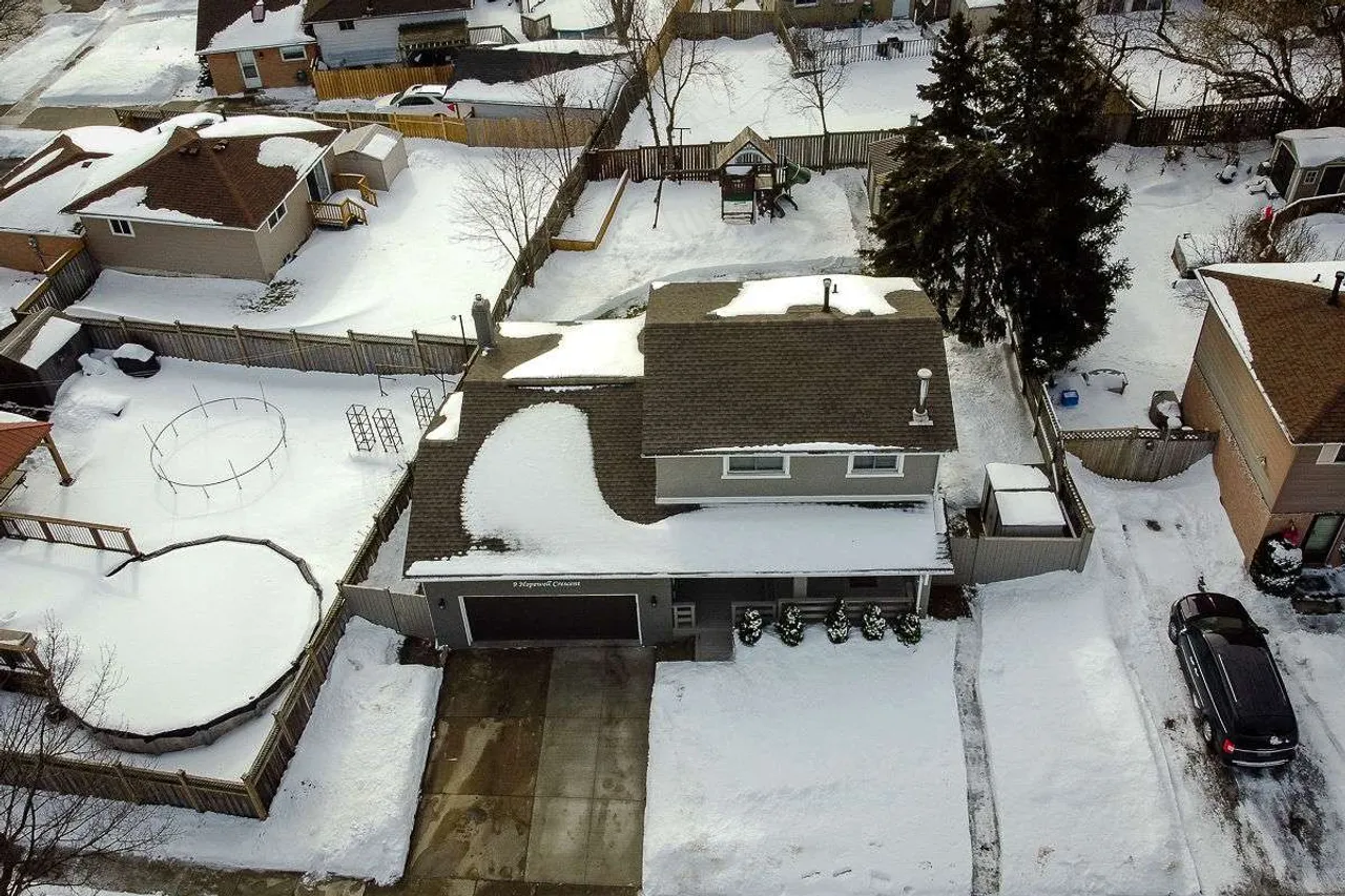 Aerial winter exterior view of 9 Hopewell Crescent showing the home, driveway, and backyard