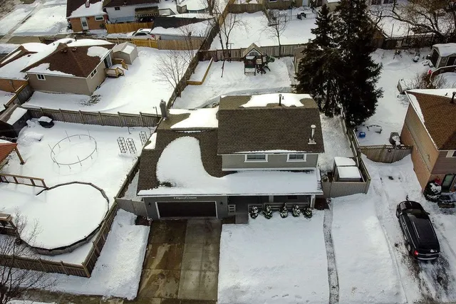 Aerial winter exterior view of 9 Hopewell Crescent showing the home, driveway, and backyard