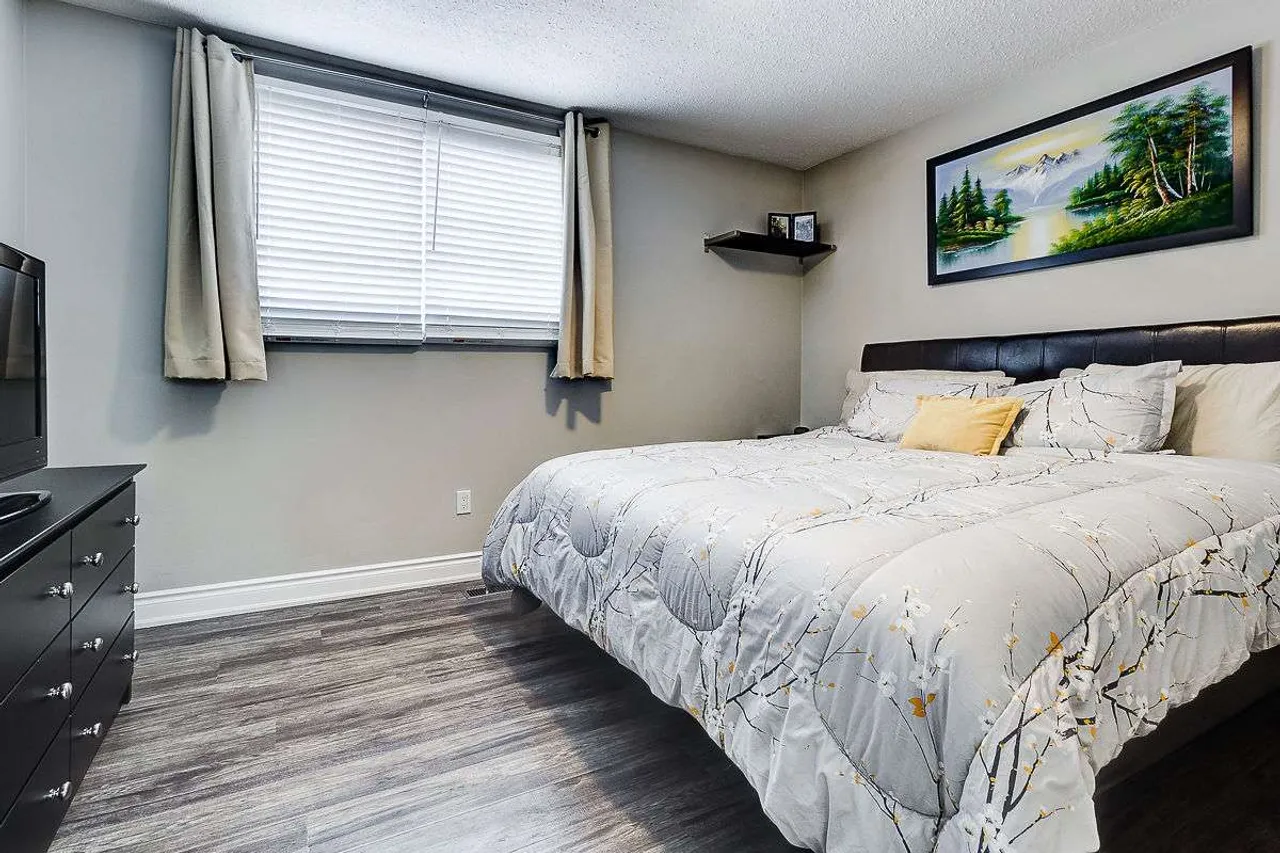 Neutral-toned bedroom with dark wood furniture