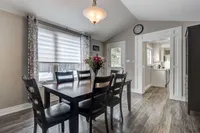 Dining room with a vaulted ceiling, pendant light, and walkout to the backyard