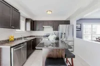 Kitchen island with stainless steel appliances and granite countertops