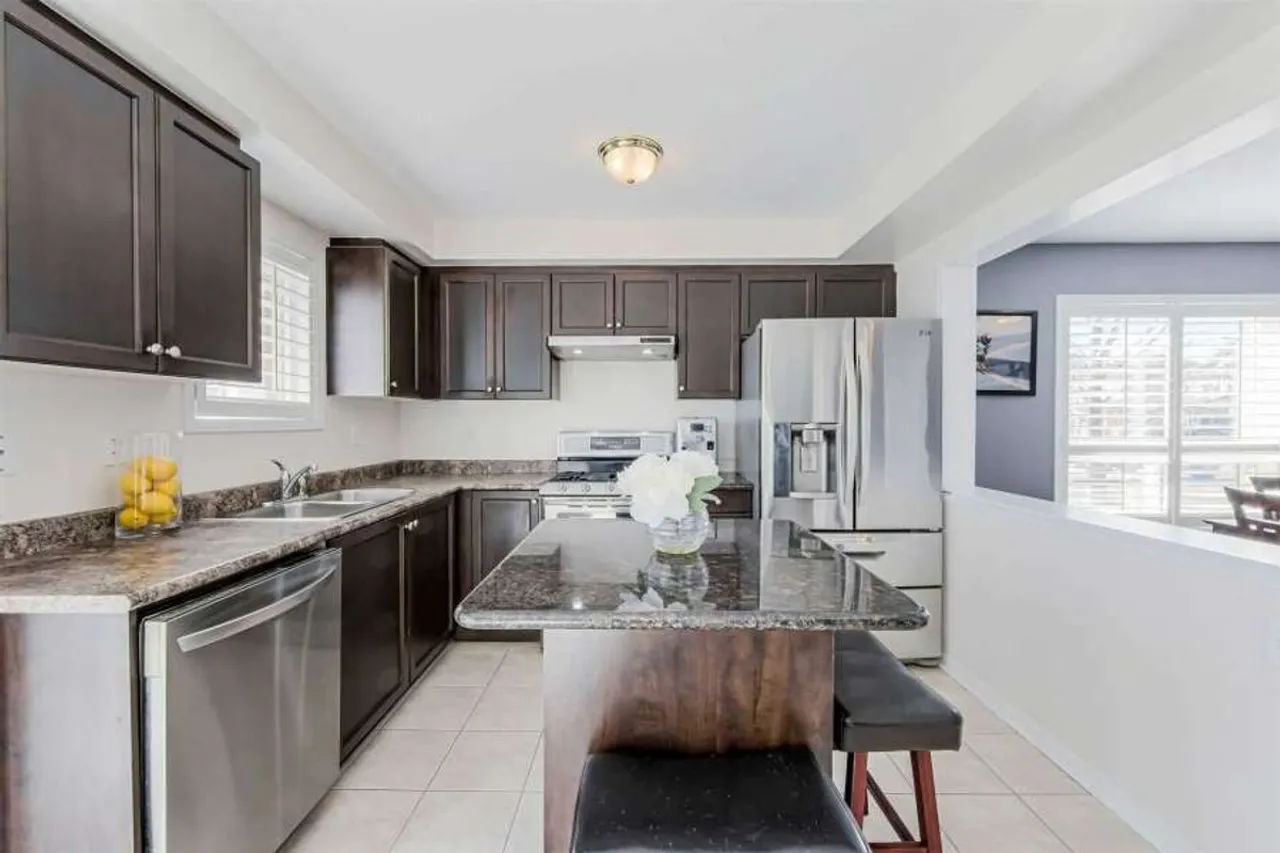 Kitchen island with stainless steel appliances and granite countertops