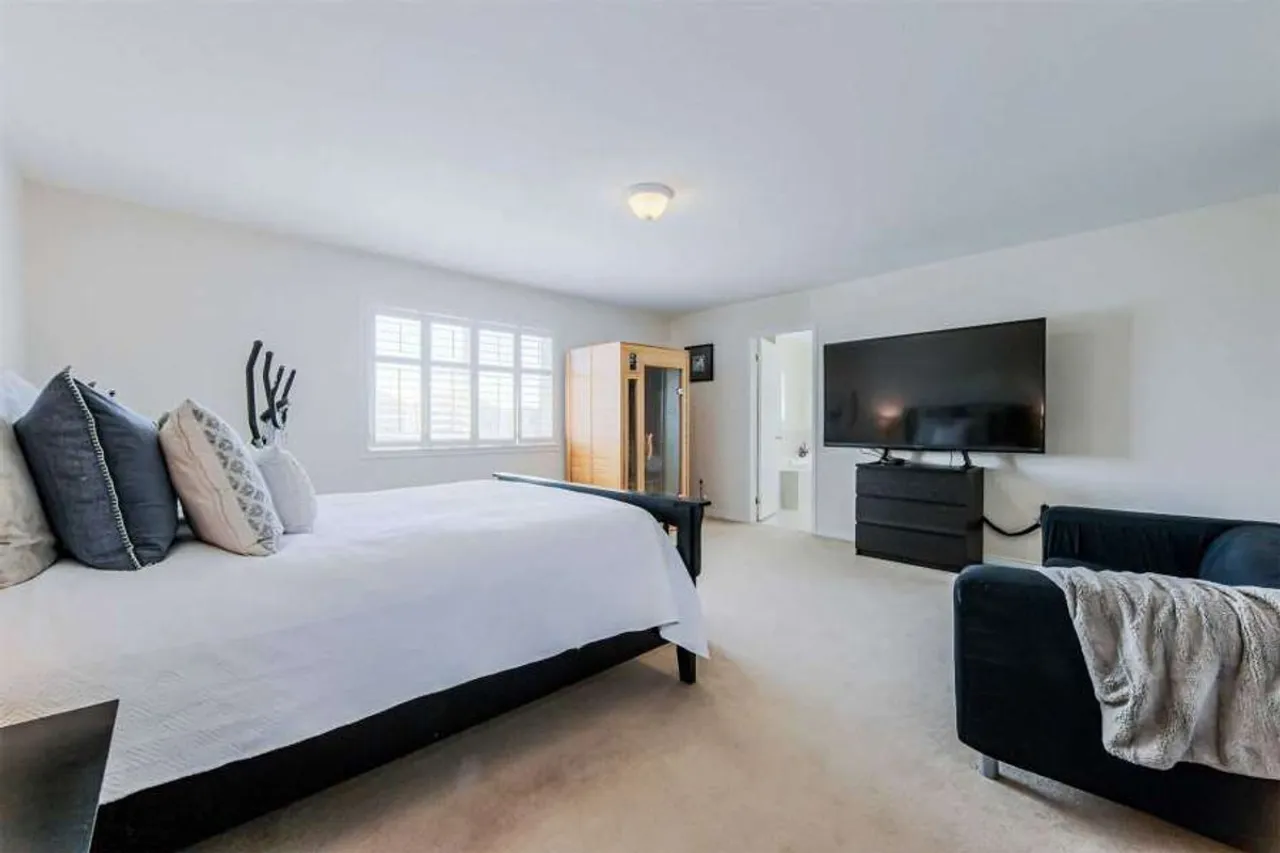 Primary bedroom with carpet flooring and a ceiling fan