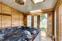 Enclosed hot tub room with skylights and a walkout to the backyard
